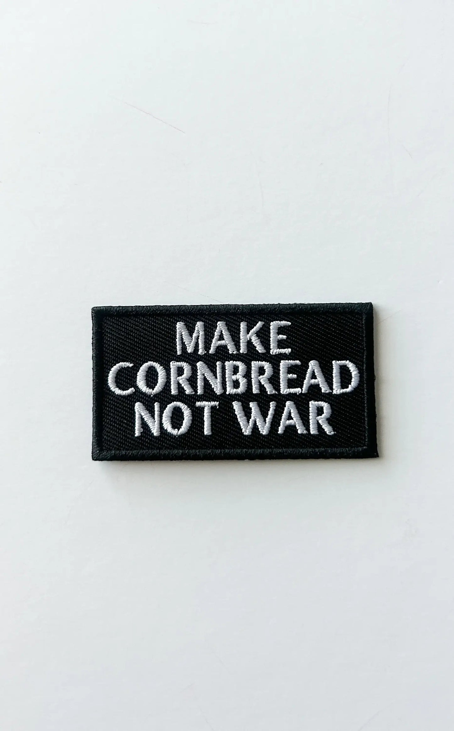 Embroidered "Make Cornbread Not War" Black Iron-on Patch